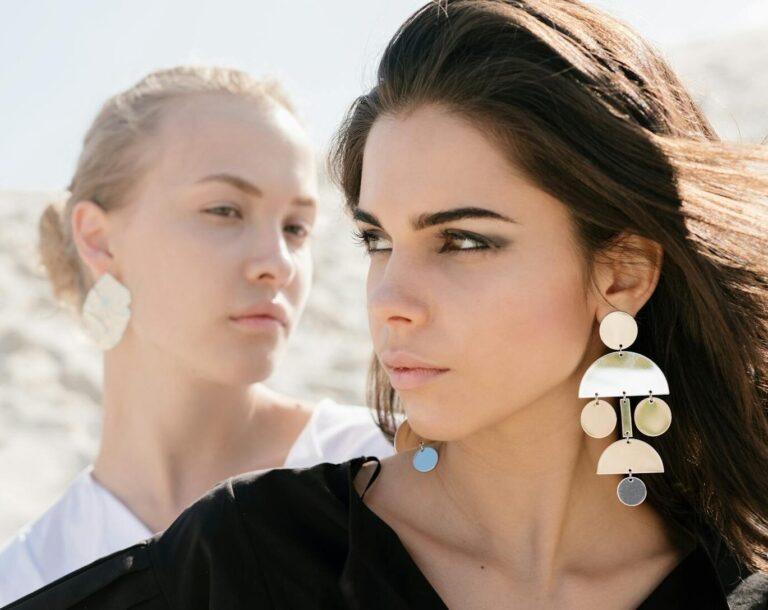 young women with contrast appearance on sandy beach