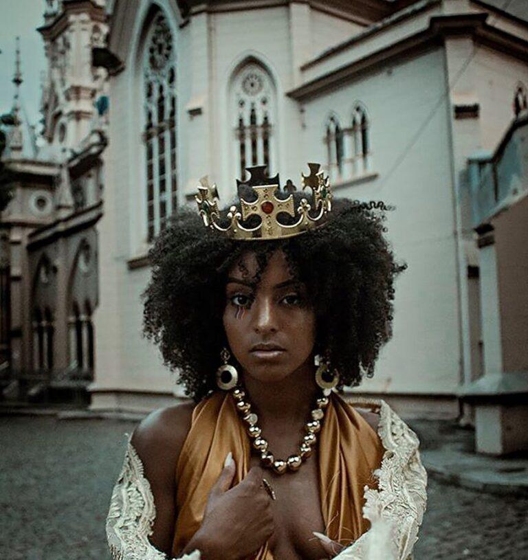 black woman in crown against cathedral