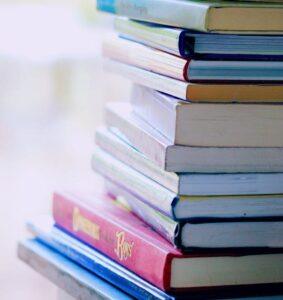 selective focus photo of pile of assorted title books