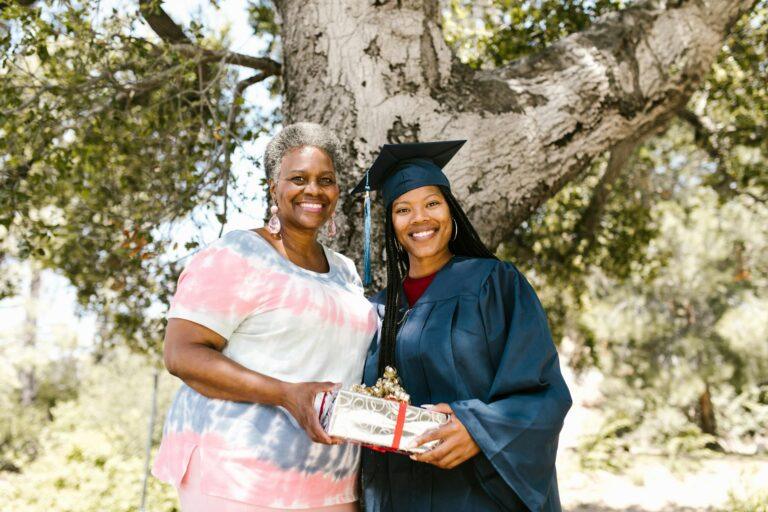 mother giving a gift to her graduating daughter